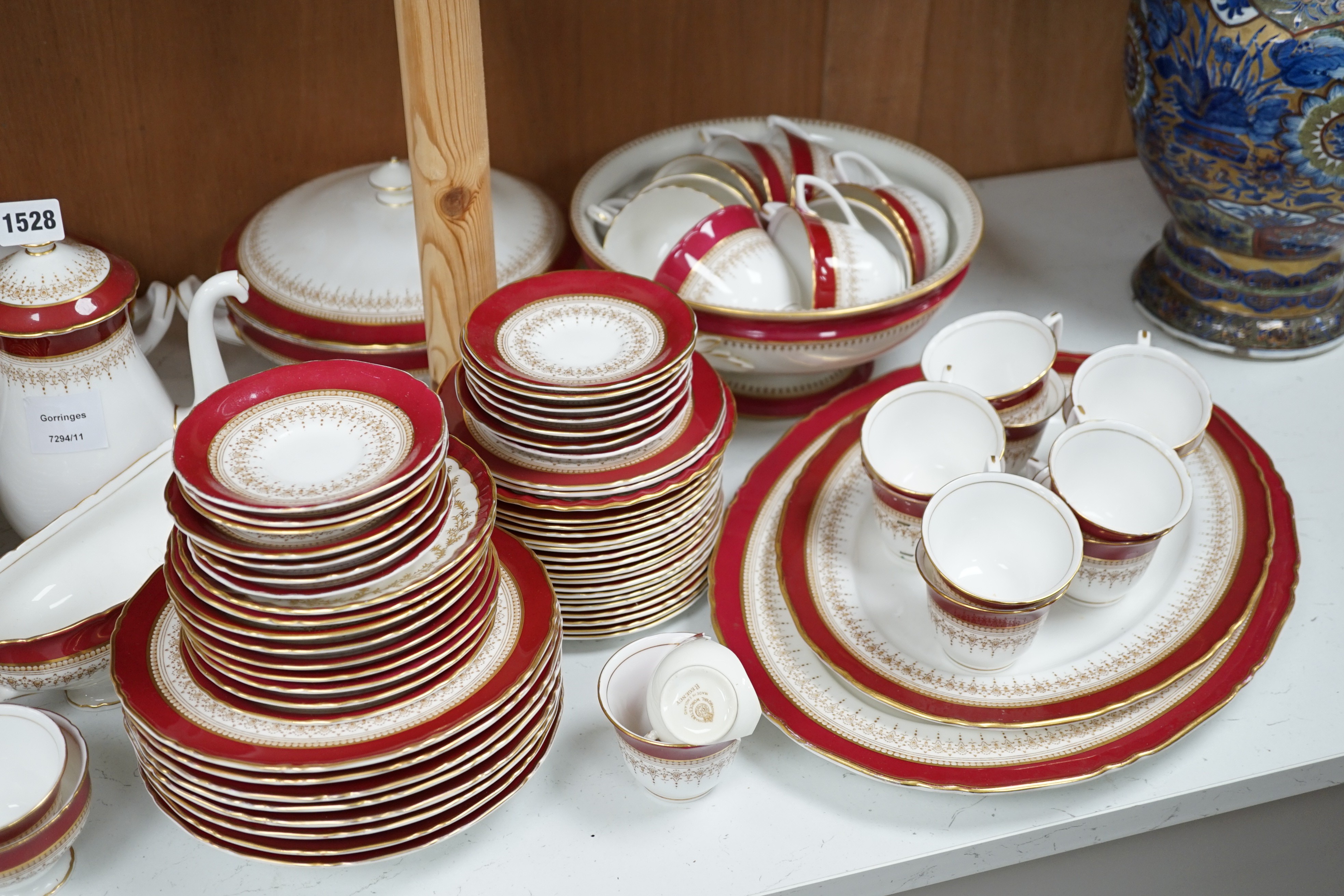 A Royal Worcester Regency pattern red and gilt bordered part dinner service